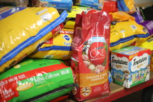 Animal food is displayed on a cart.