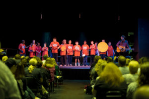 Middle school studnets on a theater stage.