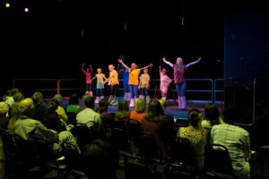 Middle school students on stage.